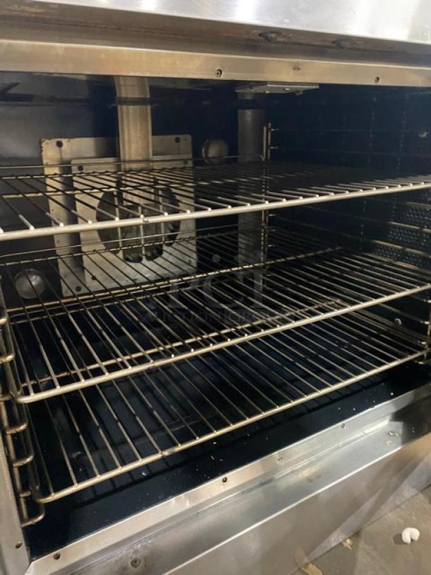 Vulcan commercial stainless steel natural gas convection oven with thermostatic control and wired oven racks, interior view.