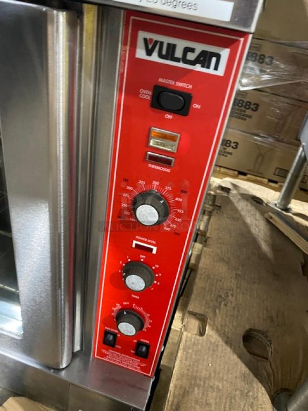 Vulcan commercial stainless steel natural gas convection oven with thermostatic controls and wired racks.