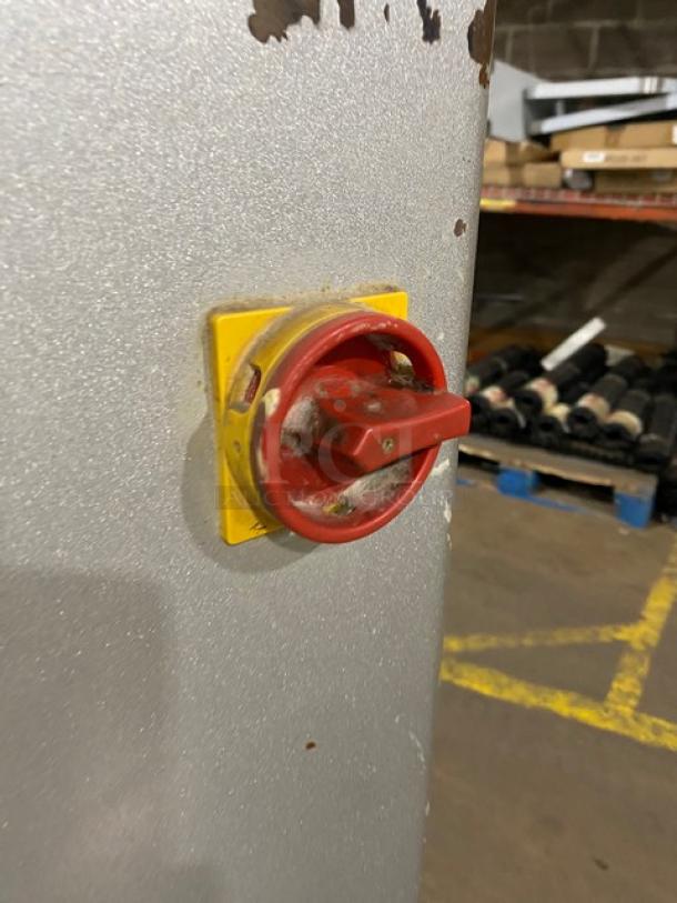 Red and yellow power switch on Thunderbird ARM60PBL planetary mixer. Industrial setting, minor wear visible.