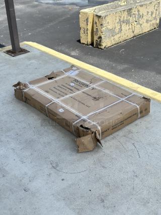 Regency 30" x 48" stainless steel equipment stand, model 600ES3048GK, in original packaging. Package shows damage.