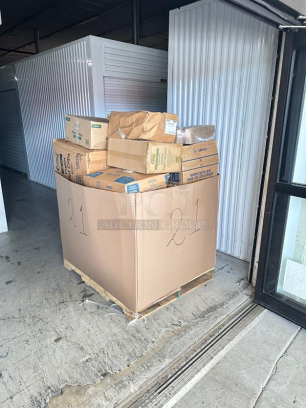 Mixed pallet on a wooden base, filled with various boxed food service items, labeled "21," placed in a warehouse setting.