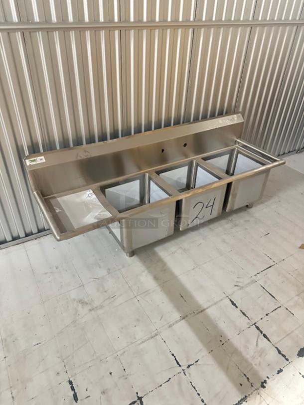 Regency 66.5" stainless steel sink, model 60S3151515GL, 3 compartments, left drainboard, new condition, slight dents.
