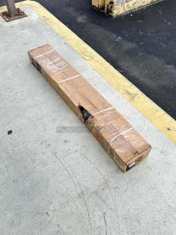 Avantco 60" strip warmer, model 177SW60INCPA, brand new, scratch and dent, packaged in cardboard box with visible damage.