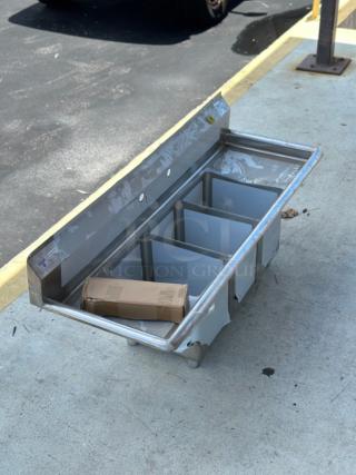 Brand new Steelton 54" stainless steel sink, model 522CS31014LK. Three compartments, two drainboards, minor dents visible.