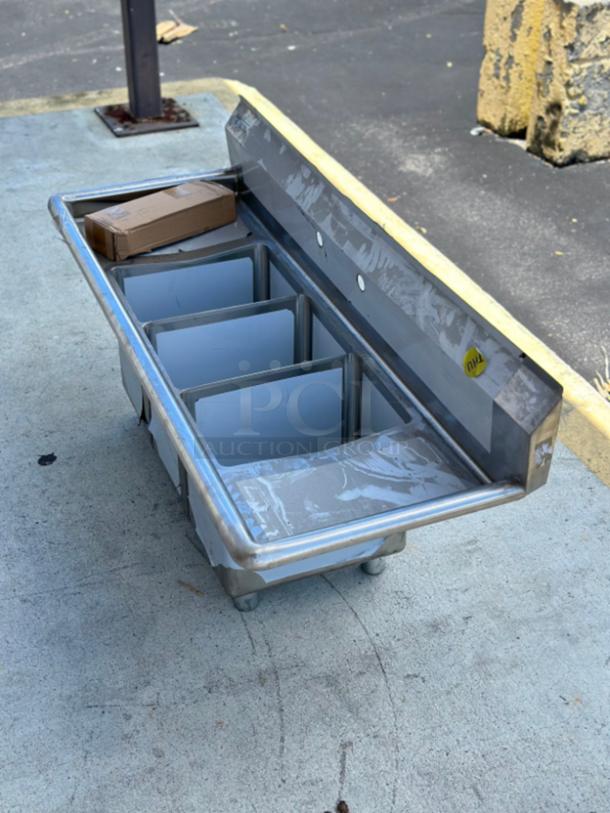 Steelton 54" 18-gauge stainless steel sink, model 522CS31014LK, with three compartments, two drainboards, brand new, minor scratches.