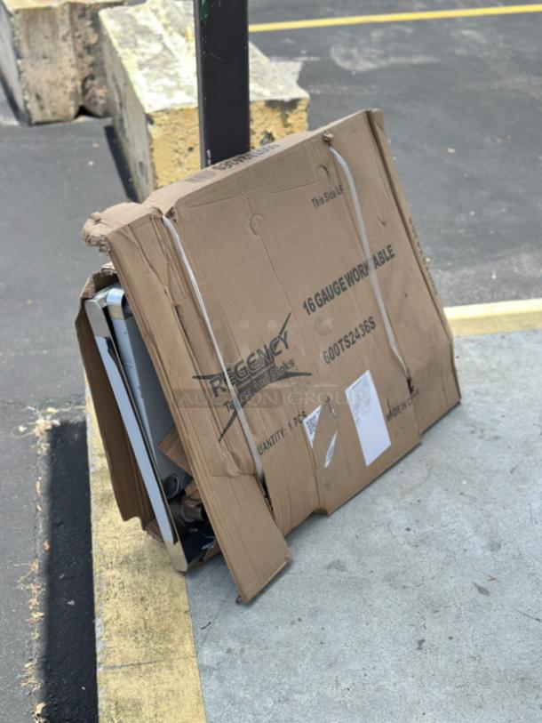 Regency 24"x36" stainless steel work table in damaged box. Model 600TS2436S. Scratch and dent condition.