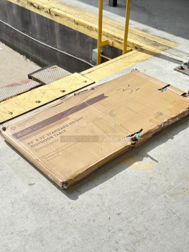 Boxed Lancaster Table & Seating Alloy 63" x 32" Emerald Green Outdoor Table, new with scratch and dent damage. Model 164RD326EMR.