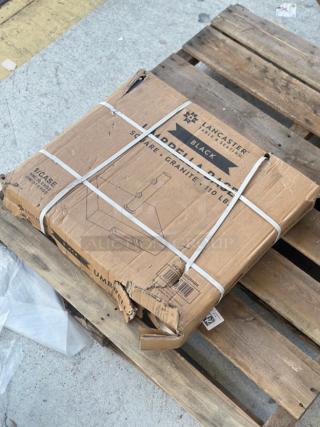 Brand new Lancaster Table & Seating 110 lb. square black granite umbrella base, model 427BASEGRNBK, in packaging with visible dents.
