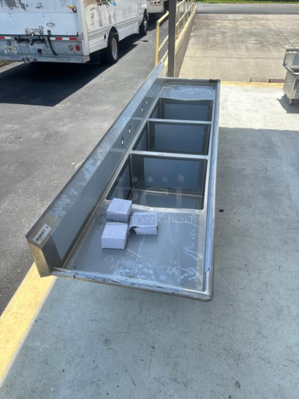 Regency 124" stainless steel three-compartment commercial sink with two drainboards, model 600S324242G, scratch and dent condition.