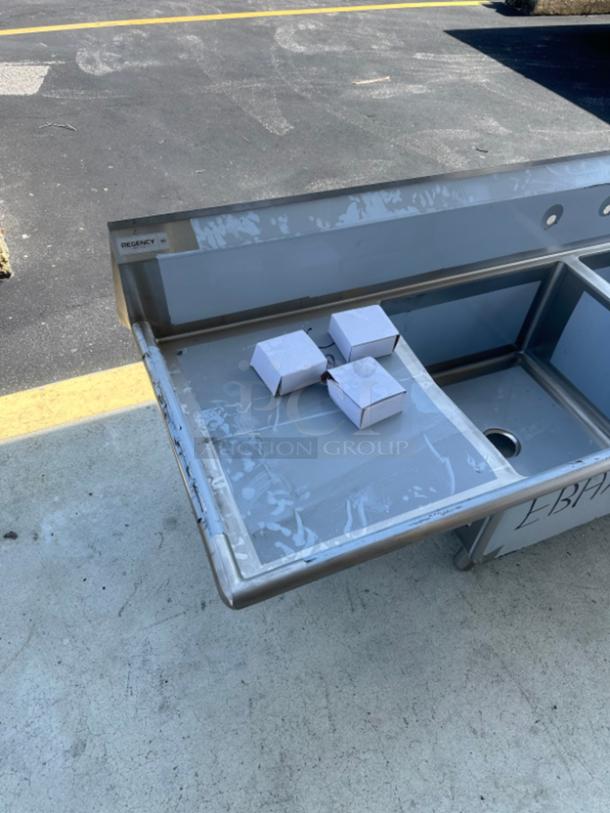 Regency 124" stainless steel commercial sink, model 600S324242G. Brand new, scratch and dent. Three compartments, two drainboards.