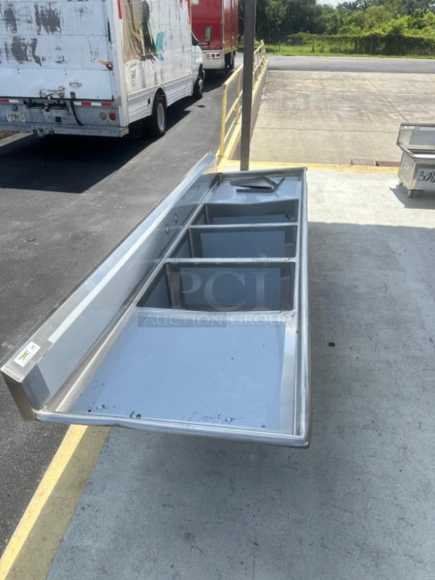 Brand new Regency 104" commercial sink, three compartments, 16 gauge stainless steel, cross bracing, dual drainboards, slight scratches.