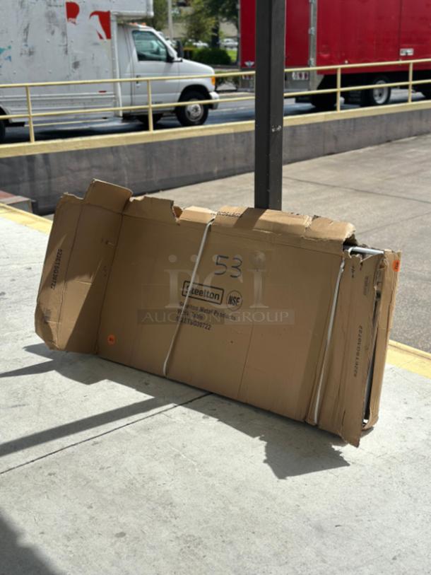 Boxed Steelton 30" x 72" 18 Gauge 430 Stainless Steel Work Table, Model 522ETSG30722, with visible packaging damage.