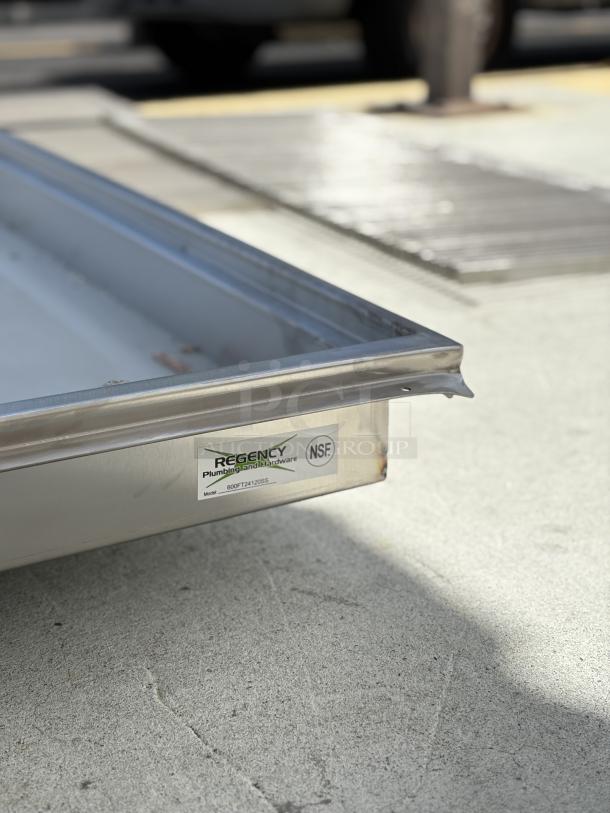 Brand new Regency 24"x120" 14-gauge stainless steel floor trough with grate, model 600FT24120SS, scratch and dent condition, NSF certified.