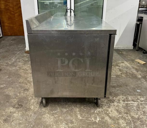TRUE TWT-44-HC worktop refrigerator with backsplash, stainless steel exterior, used condition, on casters.