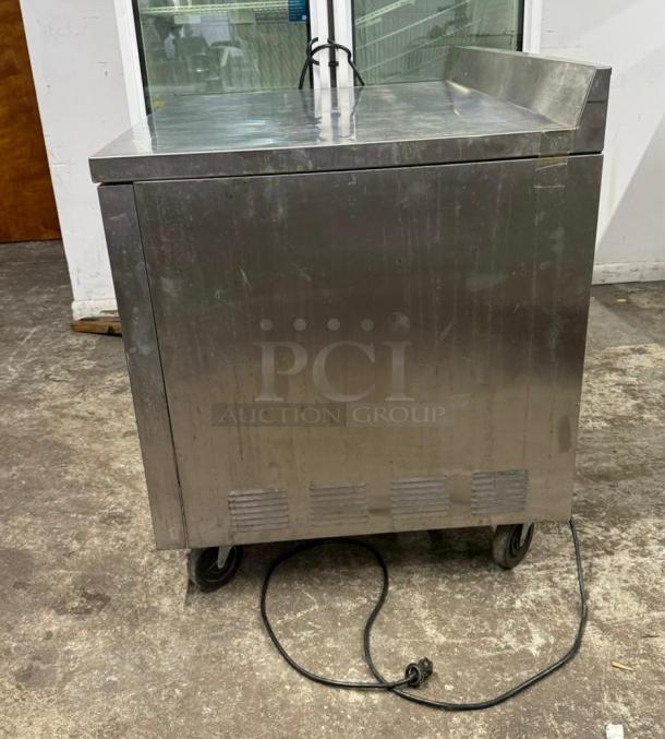TRUE TWT-44-HC worktop refrigerator with 3 9/16" backsplash, stainless steel, on casters, good condition.