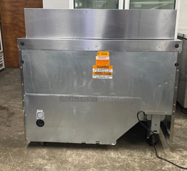 Delfield D4448NP-18M 48" refrigerated prep table, 4 drawers, stainless steel, 5" casters, R-404A refrigerant label visible.