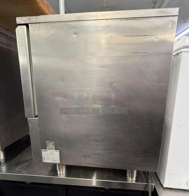 IRINOX M51-20 blast chiller, stainless steel, used condition, visible wear marks, mounted on metal legs, maker's label on front.
