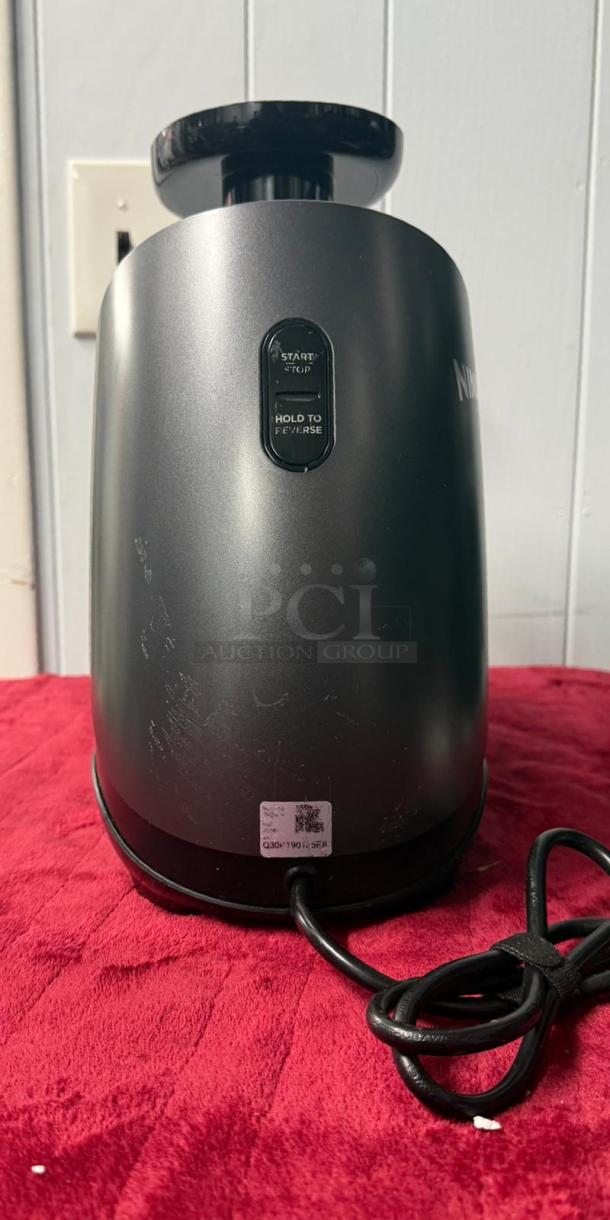Ninja® Cold Press Juicer Pro, graphite finish, 150 watts, with start/reverse buttons and visible power cord.