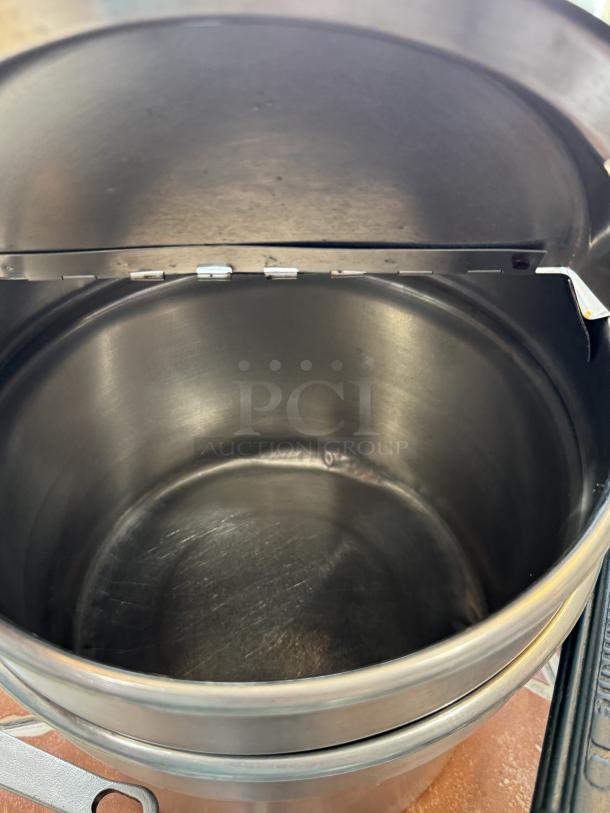 Stainless steel pots for soup or chili, clean interior, visible lid mechanism. Ideal for bulk cooking.