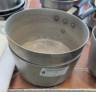 Two metal sauce pans with riveted handles, visibly worn, auction label showing "6" and "2 x bid."