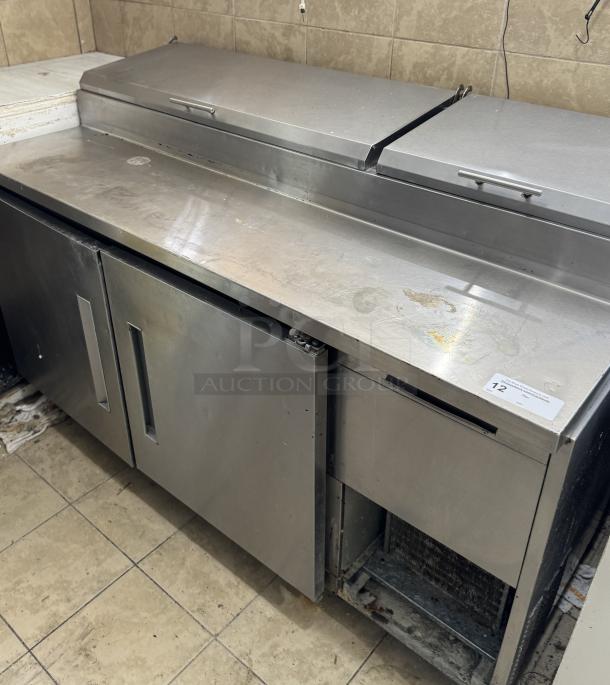 Refrigerated pizza prep table, stainless steel, dual doors, tested and working; minor surface scratches present.