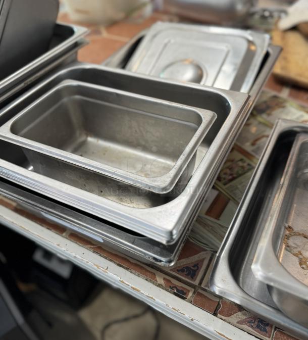 Assorted 4" steam table pans, stack of 4, stainless steel, used condition, slight wear, suitable for catering.