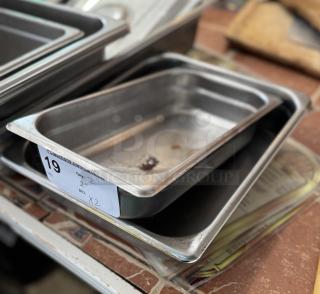 Assorted 2" steam table pans, used condition. Visible label indicates "Qty: 2, Bid: x2". Stackable, stainless steel.