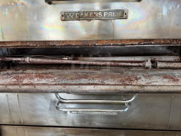Bakers Pride Pizza Oven in used condition, with visible rust and wear. Features stainless steel build and branded plate.