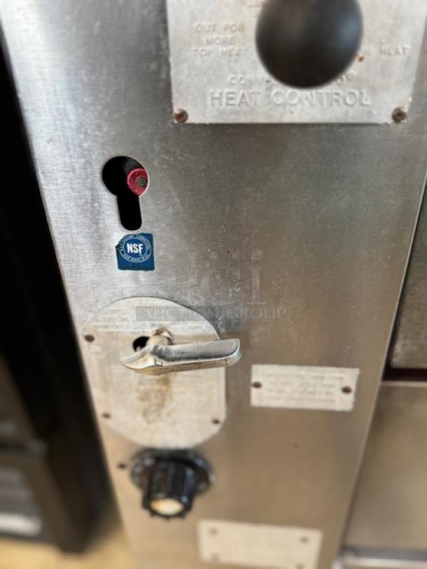 Bakers Pride pizza oven control panel with heat control dial, NSF certification label, and visible markings.