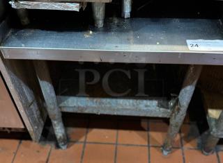 Stainless steel equipment stand, two-tier, used condition, surface marks, sturdy build, ID tag number 24 attached.