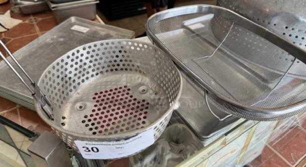 Two large strainers with perforated metal and mesh designs, showing good condition, auction label indicates item 30.