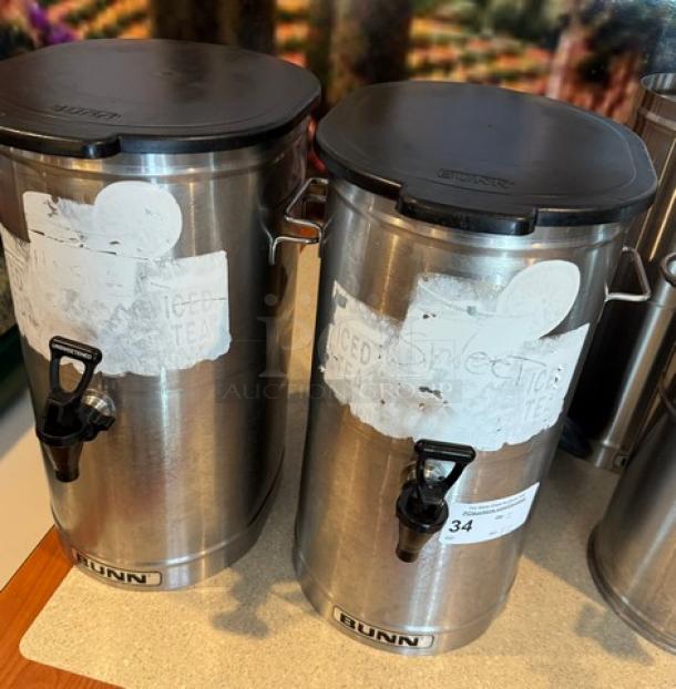 Bunn tea/beverage dispensers, stainless steel, with lids and taps, visible branding and labels, good condition, set of 2.