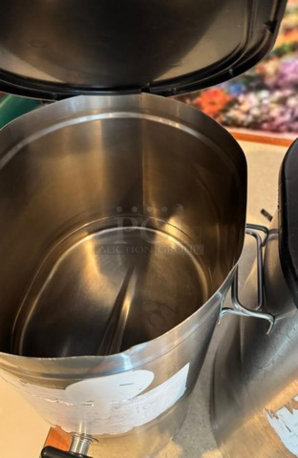 Stainless steel tea/beverage dispenser, open lid, interior view, features spigot, minor exterior wear, 2 units available.