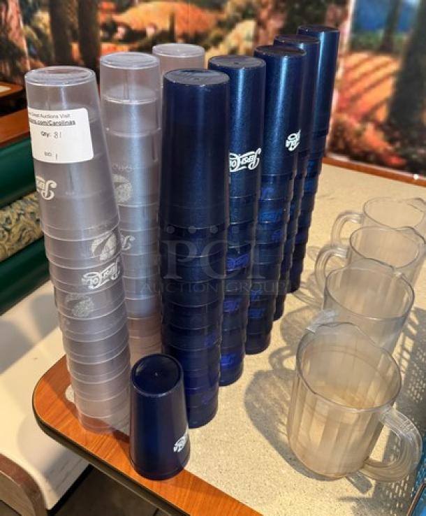 Set of 81 Pepsi plastic tumblers, 20 oz., blue and translucent, featuring Pepsi logo, good condition, stacked on a table.
