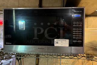 Panasonic microwave with digital display, labeled as tested and working. Includes inverter technology. Model number not visible.