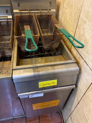 Qualite gas fryer with dual baskets, green handles, tested and working. Features yellow branding and visible wear.