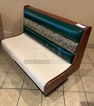 Dining room single booth with finished ends and backs, featuring a green and patterned backrest and cream seat.