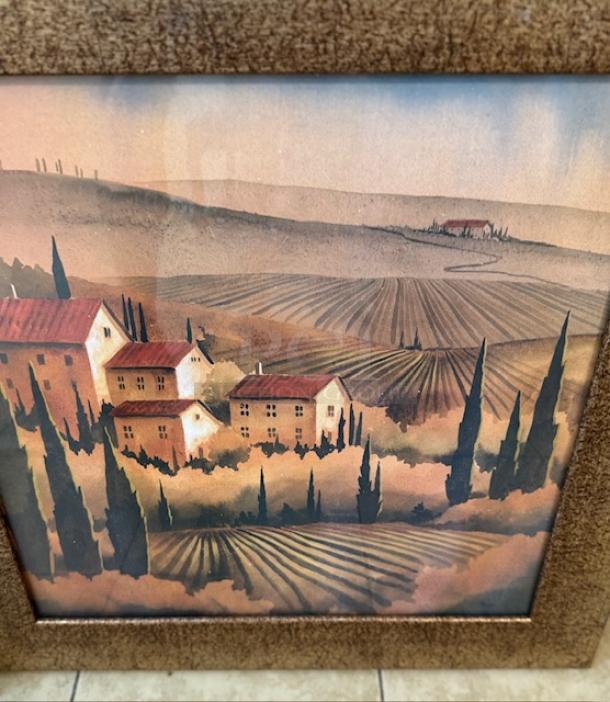 Italian artwork depicting a Tuscan landscape with villas and cypress trees; in a rustic brown frame.