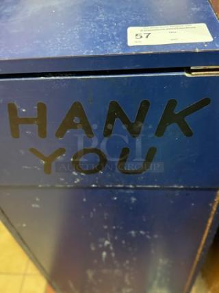 Blue wooden trash can holder with "THANK YOU" text, wear visible on surface. Top label shows item number 57.
