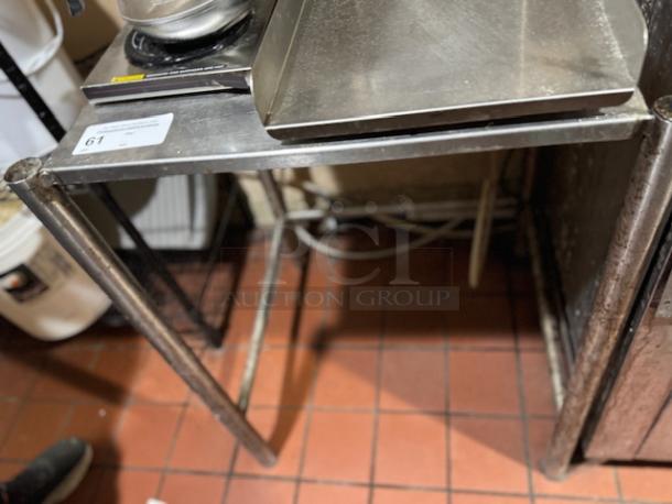 Stainless steel equipment stand with rectangular top, suitable for kitchen use. Visible label with lot number 61. Good condition.