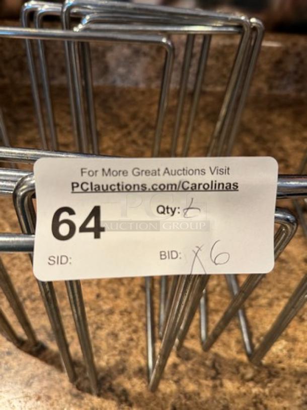 Set of 6 stainless steel pizza pan table holders, auction lot label with "64," "Qty: 6," and auction website link.