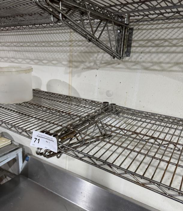 Wire wall shelving, set of four, metal, used condition with some rust. Includes bid tag labeled "71".