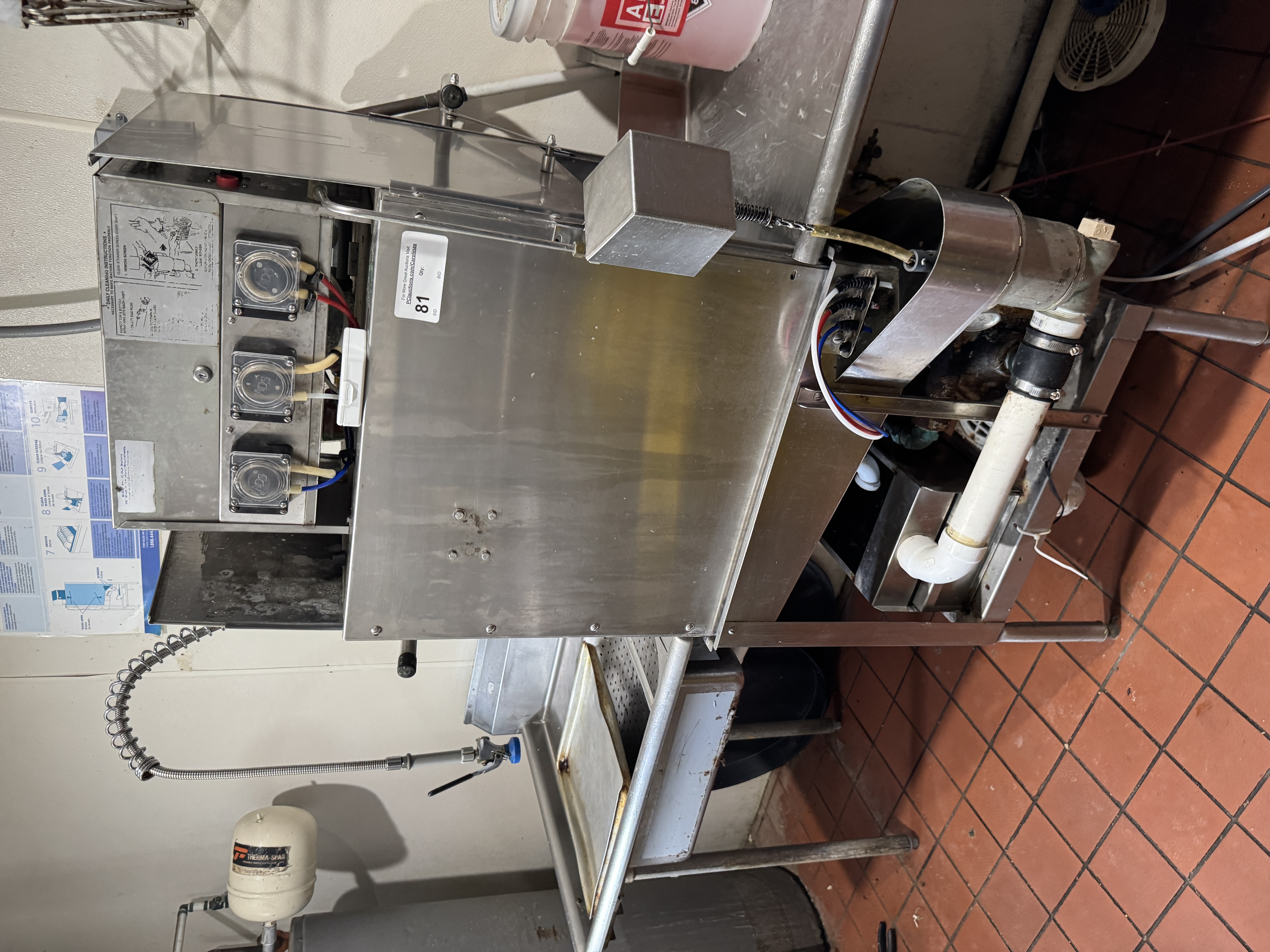 Complete commercial dish pit setup showing pass-through dishwasher with clean and dirty side tables