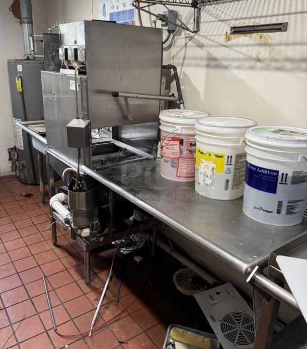 Industrial dishwasher by Diversey with three buckets of detergent, sanitizer, and rinse additive. Stainless steel, good condition.