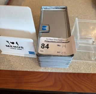 Metal check holders and plastic toothpick holder; includes bid label. Condition appears used, minor wear visible.