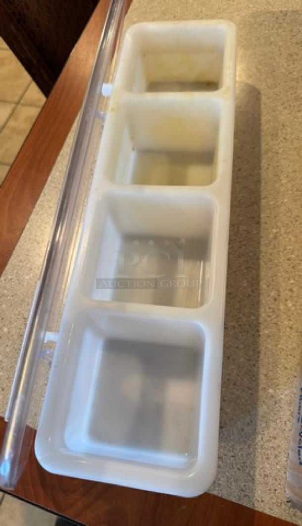 4-well condiment holder with clear lid, white plastic, lightly used. Each well is deep-set for ample storage, enhancing kitchen organization.