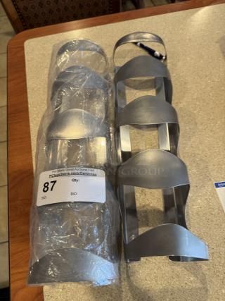 Stainless steel cup dispensers, set of 2, in good condition. One wrapped in plastic with auction label "87."