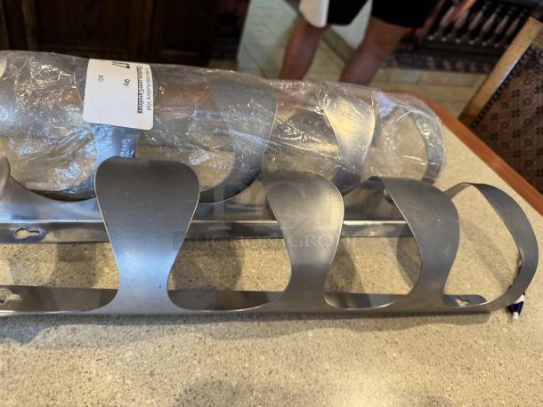 Stainless steel cup dispenser, two units. Features open slots for easy access. New, wrapped in plastic. Suitable for kitchens.