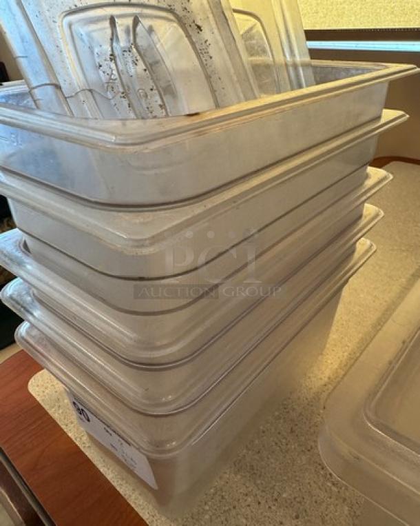 Stack of 5 clear plastic containers with 3 matching lids; slight wear visible, ideal for storage or catering use.