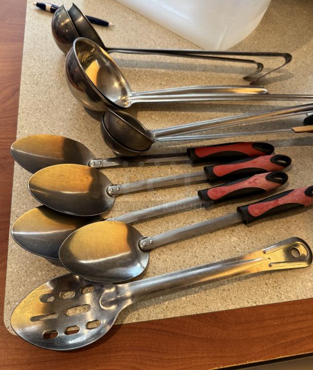 Assorted kitchen spoons and ladles, stainless steel and plastic, 11 pieces. Features variety in size and handle design.